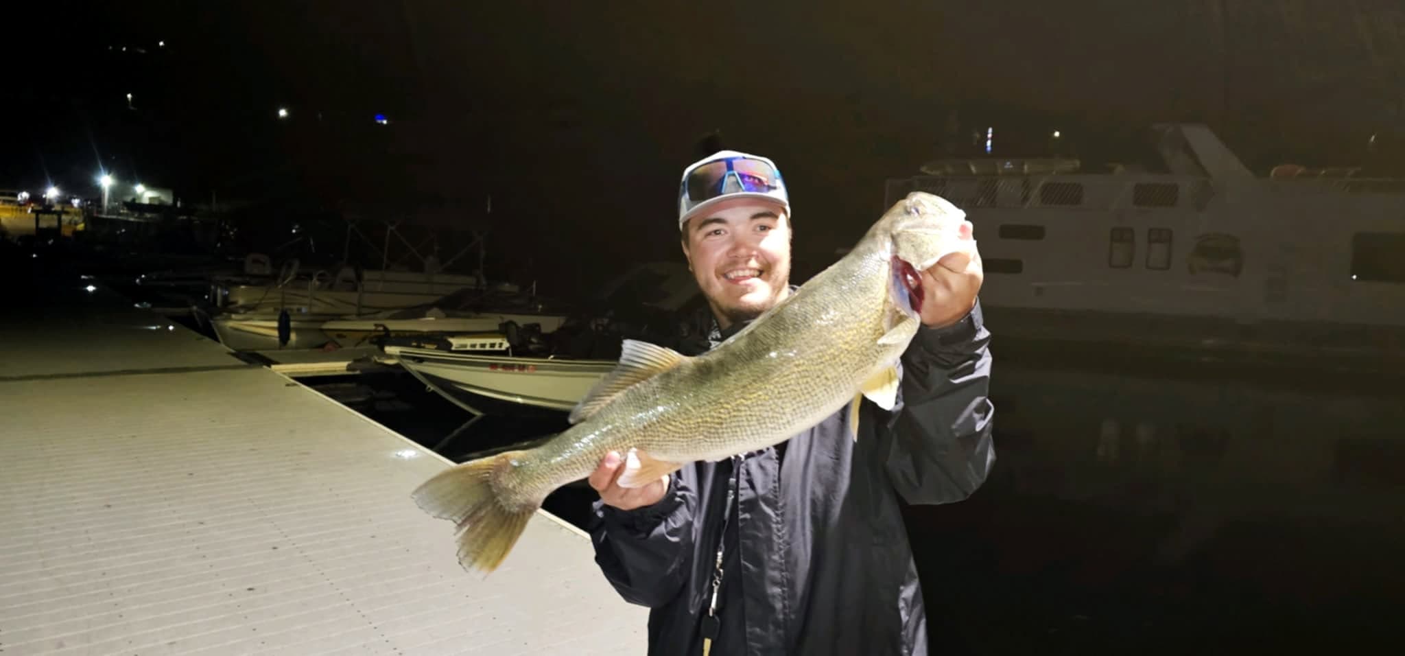 Angler holding a large catch at Two Rivers