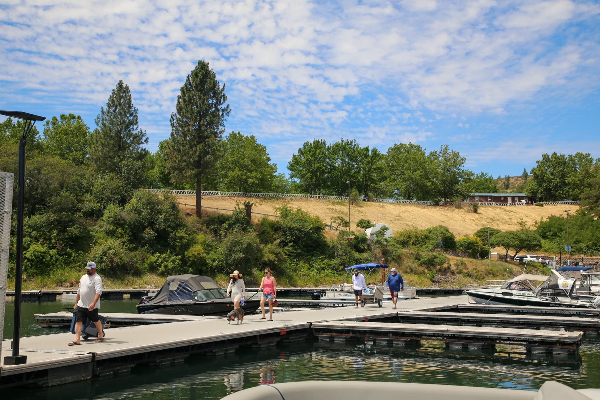Campers walking along marina enterance dock